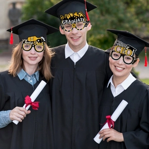 Three graduates wearing glittery gold and black party glasses props for graduation ceremony