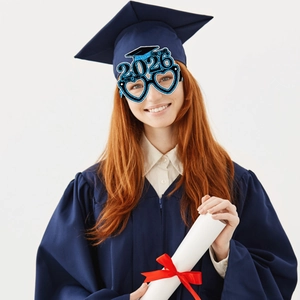 Close-up of blue glitter Class of 2026 graduation party glasses with a graduation cap