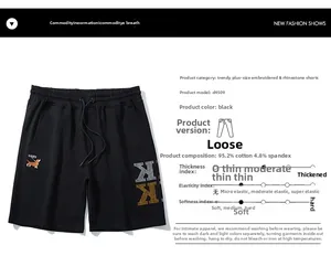 Detail of GAIEV embroidery and rhinestone K logo on black oversized cotton shorts