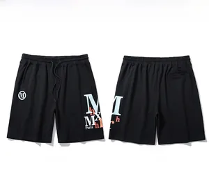 Flat lay view of black cotton shorts featuring drawstring waist and Paris logo prints