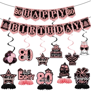 Rose gold 80th birthday party set with glitter banner, hanging swirls, and honeycomb centerpieces