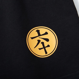 Black loose fit sports shorts with a high-contrast yellow circular graphic logo print