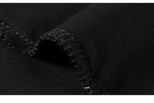 Nahaufnahme der Overlock-Stichdetails auf schwarzem Übergroßen T-Shirt-Stoff
