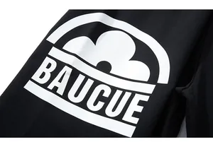 Macro view of white BAUCUE text print on premium black knitted sport shorts fabric