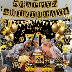 Detailed black and gold 70th birthday party set with banners, balloons and honeycomb decor