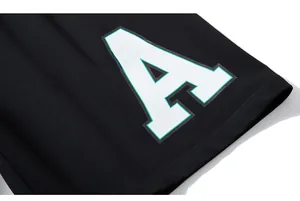 Macro shot of white letter A and logo print on black cotton loose sports shorts