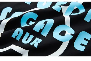 Macro view of blue gradient letter printing and cotton fabric texture on black t-shirt