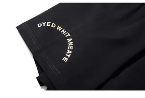Detailed macro view of gold letter printing on black cotton knit t-shirt fabric