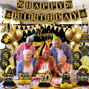 Detail of 70th birthday party set with black and gold balloons and banners