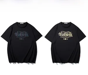 Detail of reflective and gold textured graphic prints on black cotton streetwear T-shirt