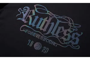 Macro detail of iridescent Ruthless and Forever Young print on black cotton T-shirt