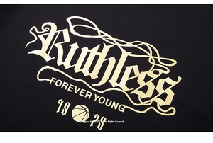 Macro detail of gothic lettering and basketball print on a black cotton oversized t-shirt