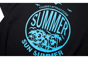 Close-up of tropical palm tree and sun print on a black oversized summer cotton t-shirt