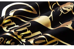Macro detail of high-quality gold foil print on black knit cotton oversized T-shirt