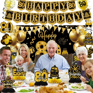 Detailed black and gold 80th birthday party set with banners balloons and decor
