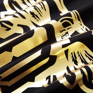 Men's loose black cotton T-shirt featuring a premium metallic gold foil letter print