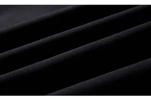Close-up of premium black cotton blend fabric with fine texture and smooth finish