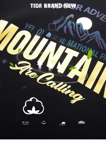 Detail of mountain graphic print on black cotton sweatshirt with 95.4% cotton fabric texture