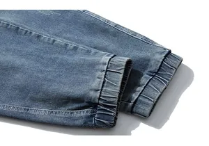 Macro shot of elastic cuffs on blue washed denim jeans with reinforced stitching detail