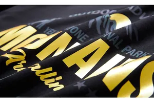 Close-up of bright yellow and grey outdoor style print on black cotton sweatshirt