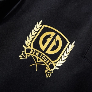 Black jogger pants with golden metallic GD shield print and New Yourk ribbon detail