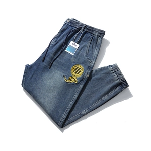 Men's blue stretch jogger jeans with golden cloud embroidery and elastic drawstring waist