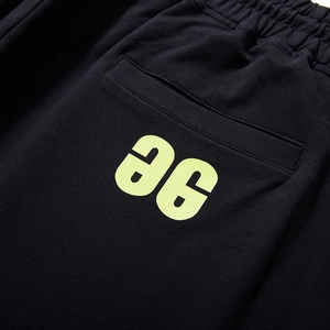 Men's loose black joggers with drawstring waist and neon green aG letter print