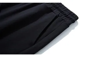 Detail of high-elastic waistband and side pockets on black men's knit sports pants