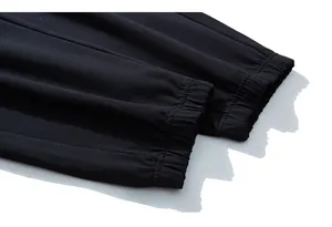 Close-up of elastic ribbed cuffs on black men's plus size joggers with knit texture