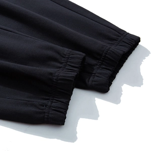 Close-up of black plus size joggers with elastic ribbed cuffs and neat stitching details