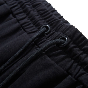 Men's athletic sweatpants with elastic drawstring waistband and metal eyelets detail