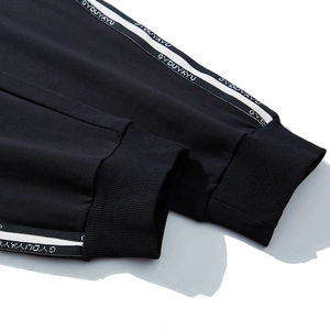 Men's athletic sweatpants in black with white side stripes and ribbed cuffs for sports