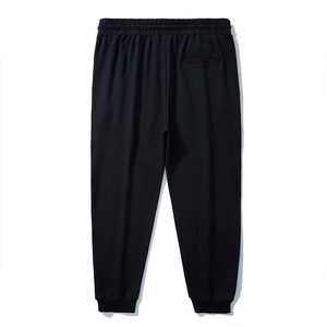 Men's oversized black joggers with elastic waist and ribbed cuffs, back view display