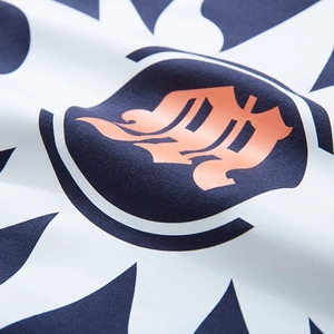Close-up of pink gothic logo and white graphic print on blue oversized cotton T-shirt
