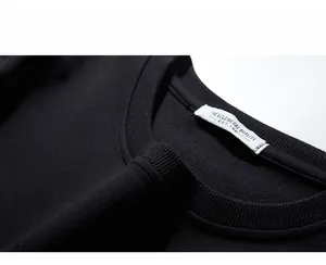 Detail of ribbed crew neck and 3XL size label on premium black cotton sweatshirt