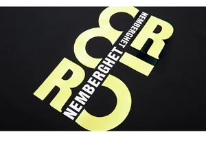 Detail of high-density black cotton tee featuring bold yellow and white screen print