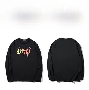 Macro detail of abstract lightning bolt print on black long-sleeved cotton T-shirt