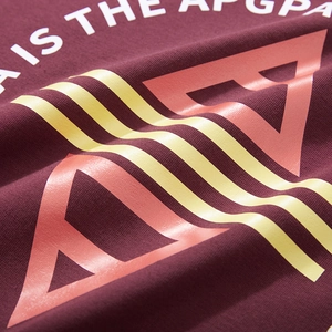 Close-up of burgundy cotton T-shirt with geometric rubberized prints and lettering