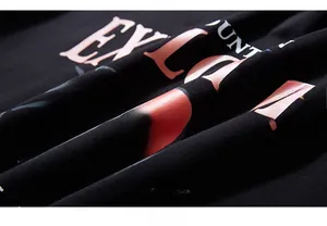 Detail of high-quality orange sunset mountain print on premium black cotton hoodie fabric