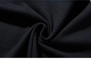 Macro view of navy blue high-density knit fabric showing fine texture and soft touch