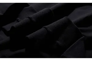 Detailed macro view of black ribbed elastic cuffs on a high-quality cotton sweatshirt