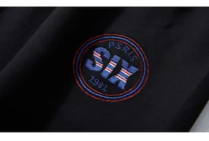 Macro detail of high-quality embroidery with letters and numbers on black cotton pants