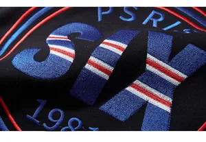 Close-up of premium colorful SIX and PSRIS 1987 embroidery on black jogger pants