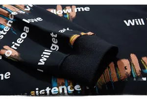 Detail of elastic ribbed cuff on black sweatshirt with colorful graffiti letter prints