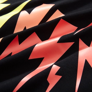 Black long-sleeve oversized tee with vibrant yellow and orange gradient lightning print