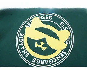 Detail of screen-printed cartoon cat logo on dark green knitted oversized sweatshirt