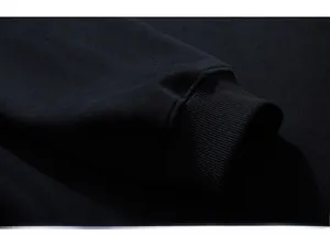 Macro shot of durable ribbed cuffs and high-density cotton fabric on navy sweatshirt