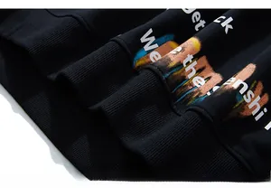Detail of black hoodie featuring vibrant paint brush strokes and ribbed cuffs