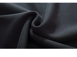 Close-up of premium dark grey knitted cotton fabric showing soft texture and fine grain