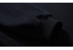 Detailed close-up of high-elastic ribbed cuffs on a black oversized sweatshirt